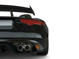 Black fast super sports car - rear wing closeup shot photo