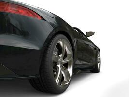 Black fast super sports car - rear wheel closeup shot photo