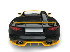 Beautiful modern cabriolet sports car - black with yellow details - back view photo