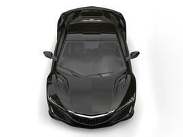 Glossy black modern super sports car - top front view photo