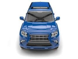 Bright rich blue modern SUV - top down front view photo