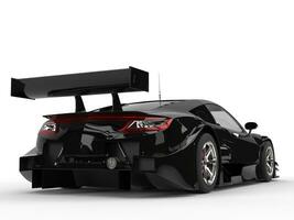 Black concept sports car - large tail wing and big taillights photo