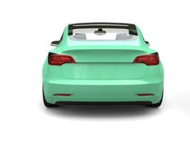 Bright pastel green modern electric car - back view photo