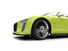 Glowing green modern cabriolet super car - front wheel closeup shot photo