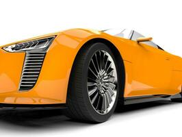 Cadmium yellow modern convertible super sports car - front wheel extreme closeup shot photo
