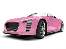 Pretty pink modern cabriolet sports car - low angle front view photo