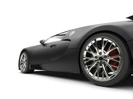 Beautiful modern matte black concept super sportscar - rear wheel closeup shot photo