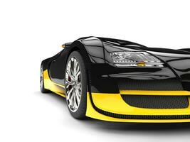 Black and yellow modern super sports car - headlight closeup shot photo