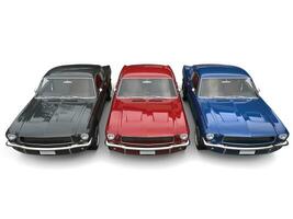 Beautiful restored vintage American muscle cars - blue, red and black - top down front view photo