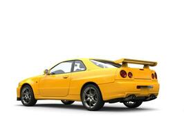 Bright yellow modern urban sports car - tail side view photo