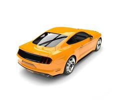 Warm orange modern sports muscle car - top down rear view photo