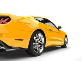 Yellow modern super muscle car - rear view closeup shot photo