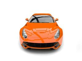 Modern hot orange fast concept car - front view closeup shot photo