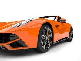 Modern hot orange fast concept car - front wheel closeup shot photo