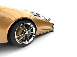 Metallic gold modern luxury sports car - rear wheel closeup shot photo