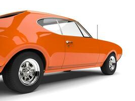 Bright tangerine orange old school muscle car - side shot photo