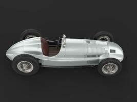 Old vintage race car in metallic silver color - top down view photo