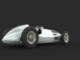 Old vintage race car in metallic silver color - back view photo