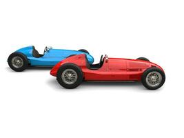 Red and blue vintage sport cars in a race, red leading - side view photo