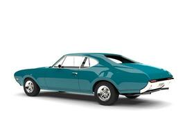 Dark aqua blue vintage restored muscle car - rear side view photo