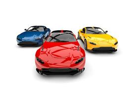 Red, blue and yellow modern electric sports cars racing -  front view shot photo