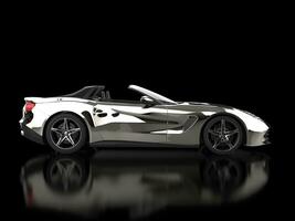 Chrome modern fast supercar - cabriolet - on black background with ground reflections - side view photo