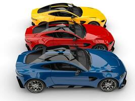 Blue, red and yellow modern sports cars side by side - top view photo