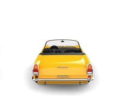 Sunny yellow vintage convertible car - tail view photo