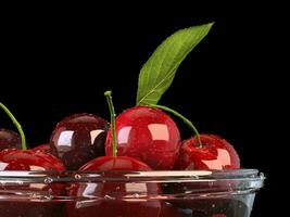 Fresh beautiful cherries in a glass bowl - closeup shot photo