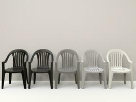 Generic plastic chairs going from black to white photo