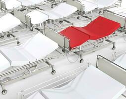 Red hospital bed stands out among many white beds photo