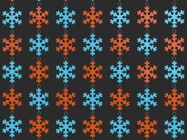 Red and blue snowflake Christmas tree decorations - dark gray background photo