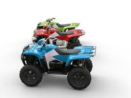 Red, green and blue four wheelers - side view photo