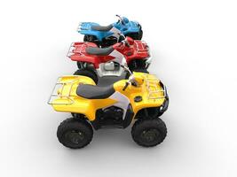 Quad bikes in primary colors - red, blue and yellow photo