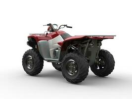 Dark red modern quad bike - focus on rear wheels photo