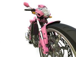 Bright pink modern motorcycle - front wheel extreme closeup shot photo