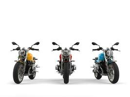 Modern red, blue and yellow chopper motorcycles - front view photo