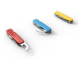 Red, blue, and yellow swiss army knifes on white background, ideal for digital and print design. photo