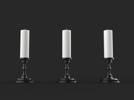 Three white wax candles on shiny black candleholders photo