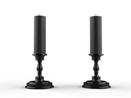 Two black wax candle on black candle holders photo