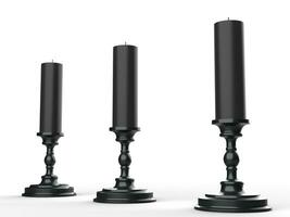 Three black wax candle on black candle holders photo