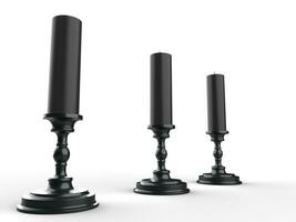 Three black wax candle on black candle holders - low angle shot photo
