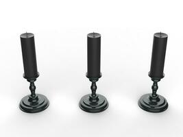 Three black wax candle on black candle holders - top down view photo