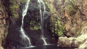 a waterfall is in the middle of a rocky area video