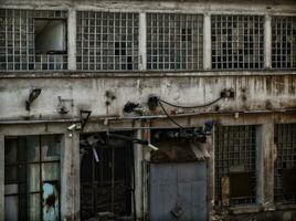 Abandoned factory - rust leaking down the walls and windows photo