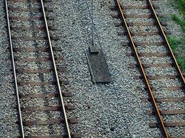 Train tracks and wires - top view shot photo