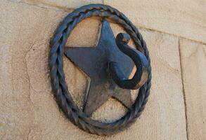 Star cast iron ornamental hook - closeup shot photo