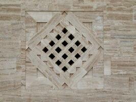 Beige stone texture with beautiful geometric design photo