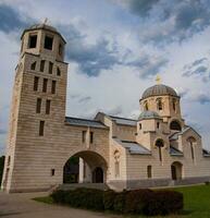 St.Luke orthodox church, green grass and brown bushes, Belgrade, Serbia photo