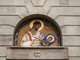 Exquisite mosaic of St.Luke above the doorway photo